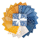 Denim & Daisy fat quarters by Lori Holt fanned out – daisy florals, plaids and text prints in blue and gold