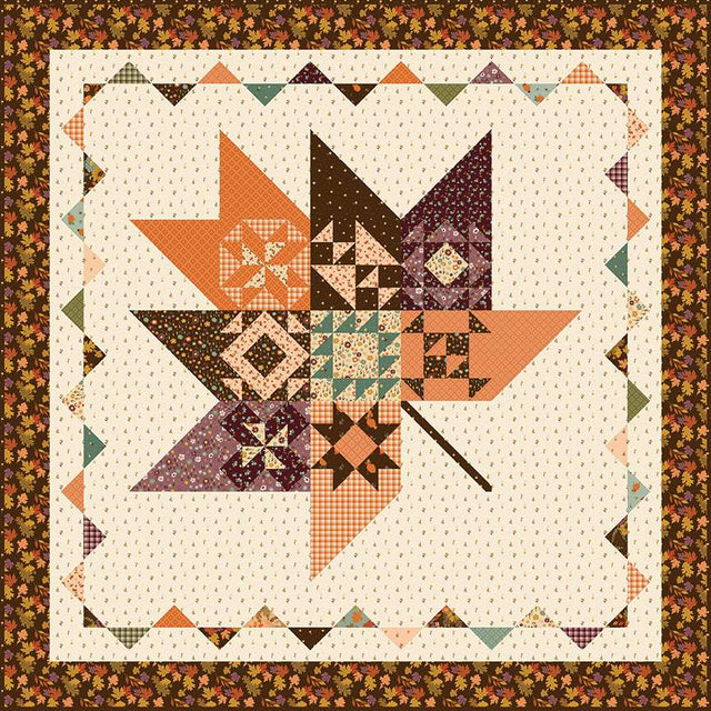 Pressed Leaves quilt pattern by Sandy Gervais showing a 62 x 62 inch quilt with a large pieced leaf surrounded by sampler blocks - P157-PRESSEDLEAVES